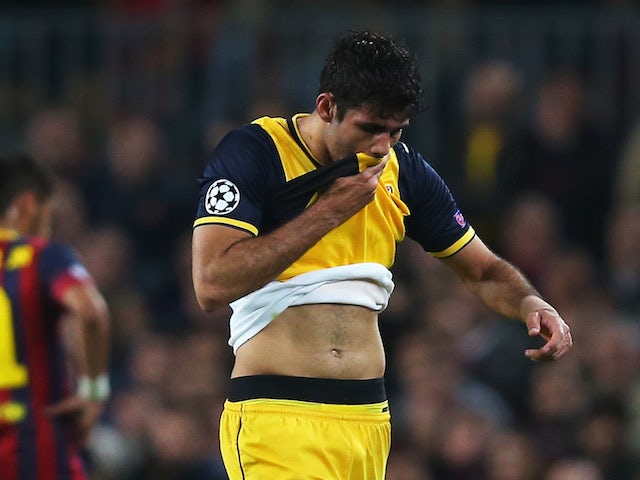 Diego Costa of Club Atletico de Madrid leaves the field injured during the UEFA Champions League Quarter Final first leg match against FC Barcelona on April 1, 2014