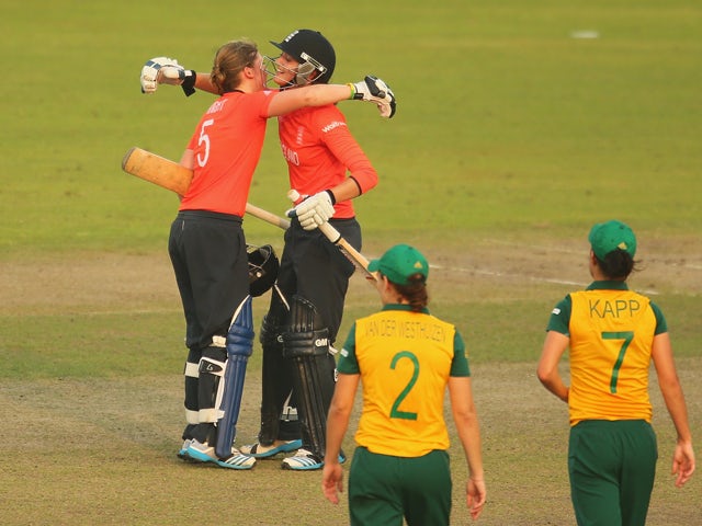 Heather Knight and Sarah Taylor of England celebrate winning the ICC Women's World Twenty20 Bangladesh 2014 2nd Semi-Final match between England Women and South Africa Women at Sher-e-Bangla Mirpur Stadium on April 4, 2014
