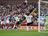 Grant Holt of Aston Villa (L) watches his effort on goal go past goalkeeper David Stockdale of Fulham during the Barclays Premier League match on April 5, 2014