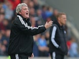 Hull City manager Steve Bruce and Swansea City manager Garry Monk on the touchline during the Barclays Premier League match between Hull City and Swansea City at KC Stadium on April 5, 2014