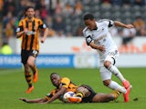 Hull City's Maynor Figueroa and Swansea City's Jonathan de Guzman compete or the ball during the Barclays Premier League match between Hull City and Swansea City at KC Stadium on April 5, 2014