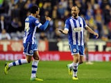 Ivan Ramis (R) of Wigan Athletic is congratulated by team-mate James Perch after scoring the opening goal during the Sky Bet Championship match against Leicester City on April 1, 2014