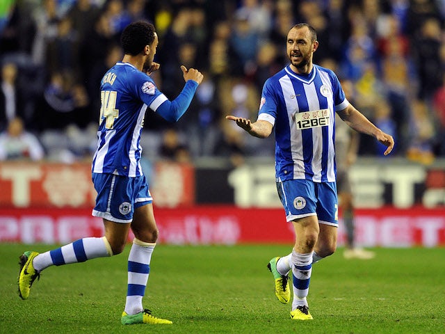 Ivan Ramis (R) of Wigan Athletic is congratulated by team-mate James Perch after scoring the opening goal during the Sky Bet Championship match against Leicester City on April 1, 2014
