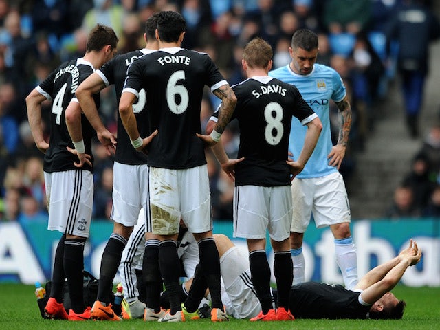 Jay Rodriguez of Southampton goes down injured after landing awkwardly during the Barclays Premier League match against Manchester City on April 5, 2014