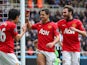 Shinji Kagawa and Juan Mata of Manchester United congratulate Javier Hernandez of Manchester United on scoring their third goal during the Barclays Premier League match between Newcastle United and Manchester United at St James' Park on April 5, 2014