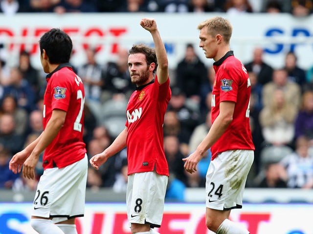 Juan Mata of Manchester United celebrates scoring the opening goal during the Barclays Premier League match between Newcastle United and Manchester United at St James' Park on April 5, 2014
