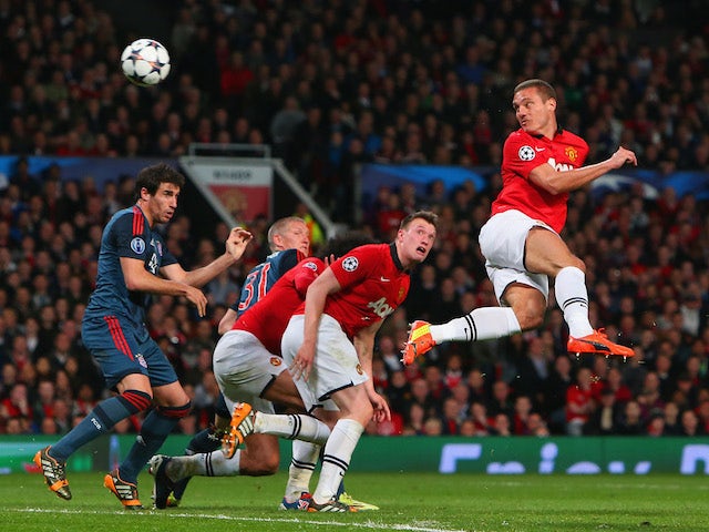 Nemanja Vidic of Manchester United heads in the first goal during the UEFA Champions League Quarter Final first leg match against Bayern Munich on April 1, 2014