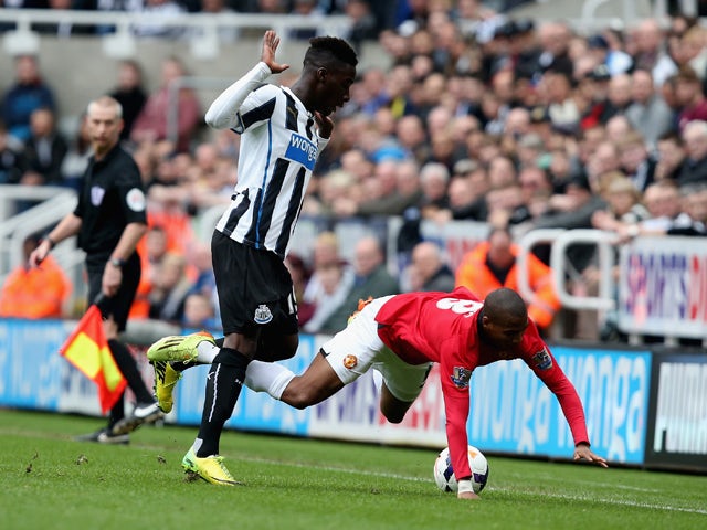 Massadio Haidara of Newcastle United and Ashley Young of Manchester United battle for the ball during the Barclays Premier League match between Newcastle United and Manchester United at St James' Park on April 5, 2014