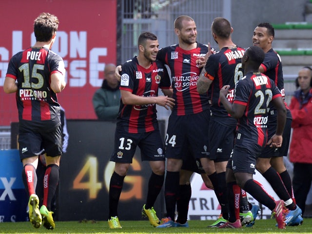 Nice's French midfielder Mathieu Bodmer is congratulated by his teammates after scoring a goal during the French L1 football match Saint-Etienne (ASSE) vs Nice (OGC) on April 6, 2014