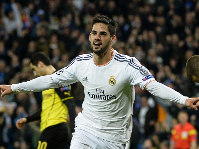 Real Madrid's midfielder Isco celebrates after scoring during the UEFA Champions League quarterfinal first leg football match Real Madrid FC vs Borussia Dortmund at the Santiago Bernabeu stadium in Madrid on April 2, 2014