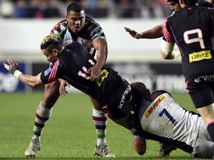 Caption:Paris' Fidjian winger Waisea Nayacalevu Vuidravuwalu vies with Harlequin's captain Chris Robshaw during the Amlin Challenge Cup rugby union match between Stade Francais and Harlequins at the Jean Bouin stadium on April 4, 2014