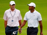 Tiger Woods (R) chats with his swing coach Hank Haney during a practice round prior to the start of the 91st PGA Championship at the Hazeltine Golf Club on August 10, 2009
