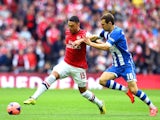 Alex Oxlade-Chamberlain of Arsenal is challenged by James McArthur of Wigan Athletic during the FA Cup Semi-Final match against Wigan Athletic on April 12, 2014