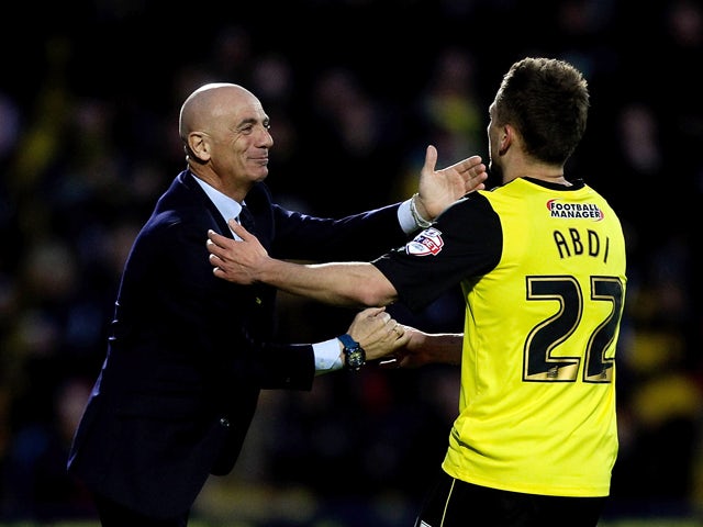 Almen Abdi of Watford celebrates with his manager Beppe Sannino after opening the scoring during the Sky Bet Championship match between Watford and Leeds United at Vicarage Road on April 8, 2014