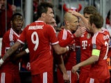 Bayern Munich's Arjen Robben celebrates with teammates after scoring his team's third goal against Manchester United in the Champions League quarter final match on April 9, 2014