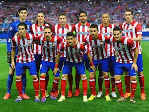 Atletico de Madrid players pose for a team photo before kick-off in the Champions League quarter final match against Barcelona on April 9, 2014