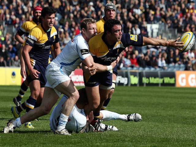 Augustin Creevy of Worcester Warriors passes out of the tackle by Matt Jess of Exeter Chiefs during the Aviva Premiership match on April 12, 2014