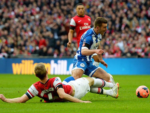 Per Mertesacker of Arsenal fouls Callum McManaman of Wigan Athletic in the penalty area during the FA Cup semi-final at Wembley on April 12, 2014