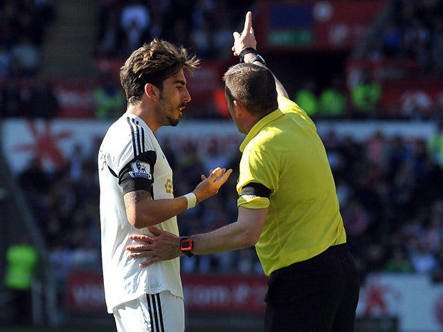 Swansea's Chico Flores is sent off by referee Phil Dowd against Chelsea during the first half of the Premier League match on April 13, 2014