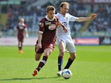 Torino's Ciro Immobile and Genoa's Giovanni Marchese in action during the Serie A match on April 13, 2014