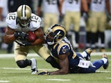 Marques Colston #12 of the New Orleans Saints is tackled after making a catch against Darian Stewart #20 of the St. Louis Rams at the Edward Jones Dome on December 15, 2013