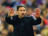 Atletico Madrid head coach Diego Simeone gestures during the Champions League quarter final match against Barcelona on April 9, 2014