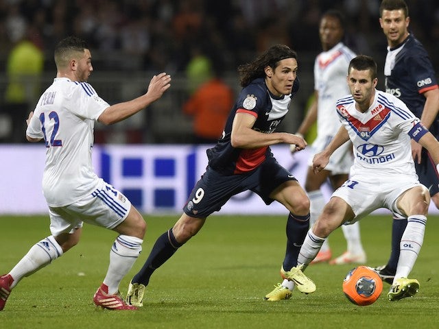 Paris' Uruguayan forward Edinson Cavani (C) vies for the ball with Lyon's French midfielder Jordan Ferri (L) and Lyon's French midfielder Maxime Gonalons during a match on April 13, 2014
