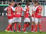 Reims' Gaetan Charbonnier celebrates with team mates after scoring the opening goal against Saint-Etienne during the Ligue 1 match on April 13, 2014 