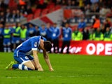 Wigan Athletic captain Gary Caldwell slumps to the ground after missing the first penalty of the FA Cup semi-final shootout against Arsenal at Wembley on April 12, 2014