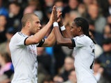 Hugo Rodallega of Fulham (R) celebrates with Pajtim Kasami as he scores their first goal during the Barclays Premier League match against Norwich on April 12, 2014