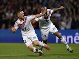 Lyon's French midfielder Jordan Ferri (L) is congratuled by his teammate French forward Jimmy Briand after scoring during the French L1 football match against PSG on April 13, 2014