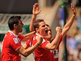 Sevilla's Kevin Gameiro celebrates after scoring the opening goal against Real Betis during the La Liga match on April 13, 2014