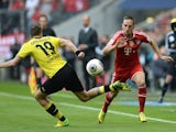 Bayern Munich's French midfielder Franck Ribery (R) and Dortmund's midfielder Kevin Grosskreutz (L) vie for the ball during the German first division Bundesliga football match on April 12, 2014