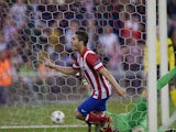 Atletico Madrid's Koke celebrates after scoring the opening goal against Barcelona during their Champions League quarter final match on April 9, 2014