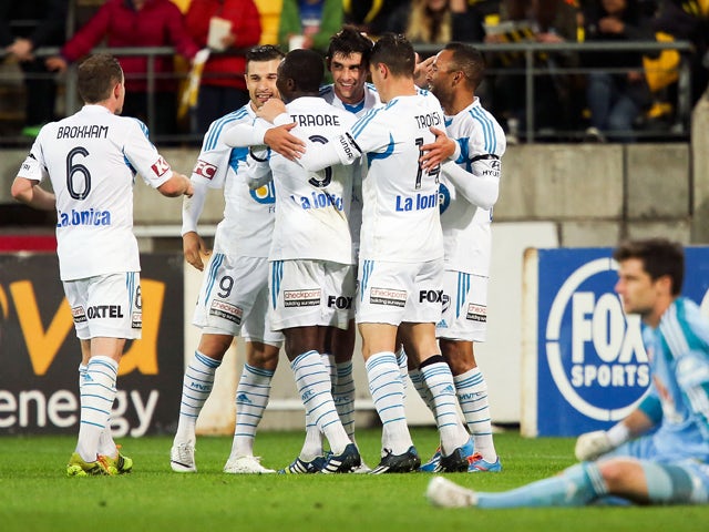 Guilherme Finkler of the Victory is congratulated by teammates after scoring a goal during the round 27 A-League match between Wellington Phoenix and Melbourne Victory at Westpac Stadium on April 12, 2014