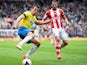 Steven Taylor of Newcastle United battles with Geoff Cameron of Stoke City during the Barclays Premier League match between Stoke City and Newcastle United at Britannia Stadium on April 12, 2014