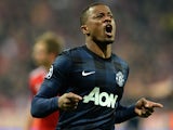Manchester United's Patrice Evra celebrates after scoring the opening goal against Bayern Munich in the Champions League quarter final match on April 9, 2014