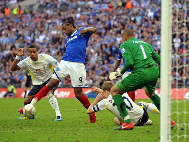 Portsmouth's French player Fredrique Piquionne scores the opening goal past Tottenham Hotspur's Brazilian goalkeeper Heurelho Gomes in extra-time of the FA Cup semi-final football match between Tottenham Hotspur and Portsmouth at Wembley Stadium, north Lo