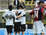 Parma's Raffaele Palladino celebrates with team mates after scoring the equaliser against Bologna during the Serie A match on April 13, 2014