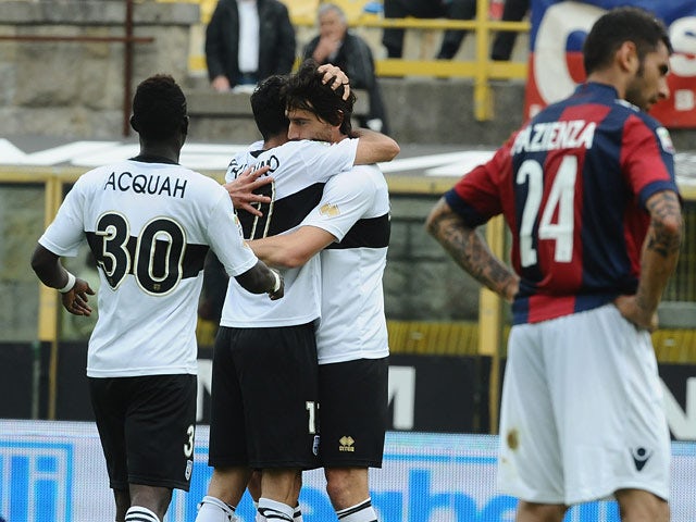 Parma's Raffaele Palladino celebrates with team mates after scoring the equaliser against Bologna during the Serie A match on April 13, 2014