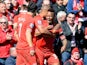 Liverpool's Raheem Sterling celebrates with team mates after scoring the opening goal against Manchester City during the Premier League match on April 13, 2014
