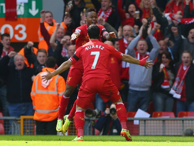 Raheem Sterling of Liverpool celebrates his early goal against Manchester City with teammate Luis Suarez at Anfield on April 13, 2014