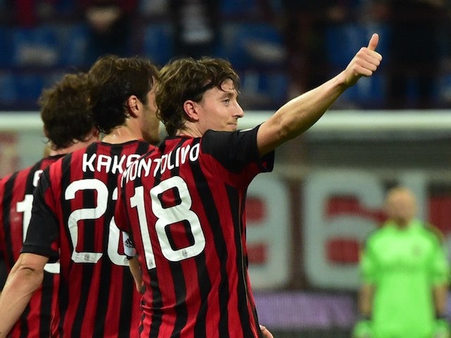 AC Milan's midfielder Riccardo Montolivo (C) celebrates with teammates after scoring a goal during the Serie A football match between AC Milan and Catania at San Siro stadium in Milan on April 13, 2014