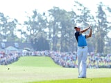 Rory McIlroy of Northern Ireland watches his approach shot on the first hole during the third round of the 2014 Masters Tournament at Augusta National Golf Club on April 12, 2014