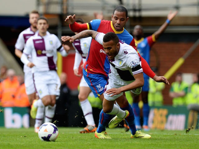 Ryan Bertrand of Aston Villa tangles with Jason Puncheon of Crystal Palace during the Barclays Premier League match on April 12, 2014