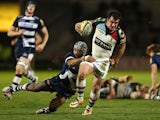 Dave Ward of Harlequins is tackled by Sam Tuitupou of Sale Sharks during the Aviva Premiership match between Sale Sharks and Harlequins at AJ Bell Stadium on April 11, 2014
