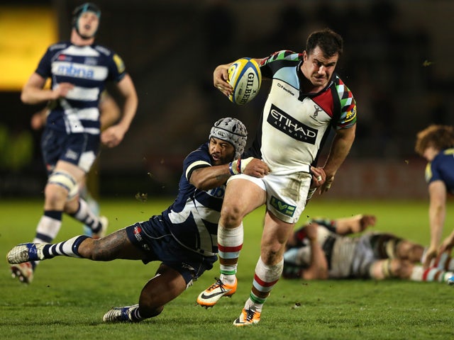 Dave Ward of Harlequins is tackled by Sam Tuitupou of Sale Sharks during the Aviva Premiership match between Sale Sharks and Harlequins at AJ Bell Stadium on April 11, 2014
