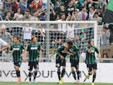 Sassuolo's Simone Zaza celebrates with team mates after scoring the opening goal against Cagliari during the Serie A match on April 12, 2014