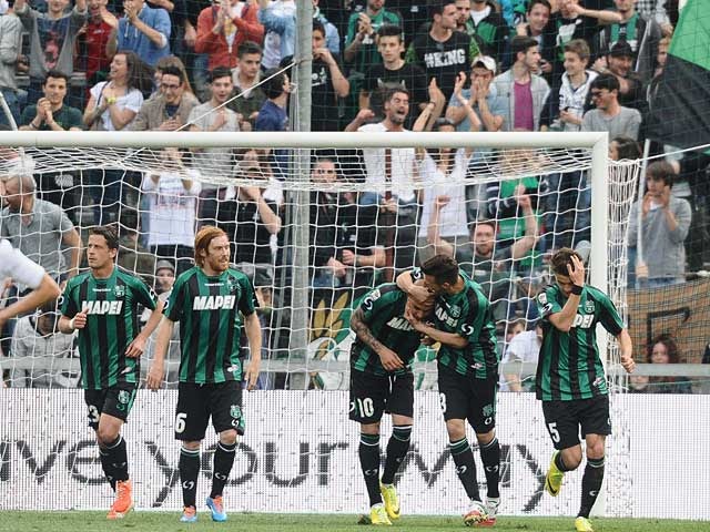 Sassuolo's Simone Zaza celebrates with team mates after scoring the opening goal against Cagliari during the Serie A match on April 12, 2014