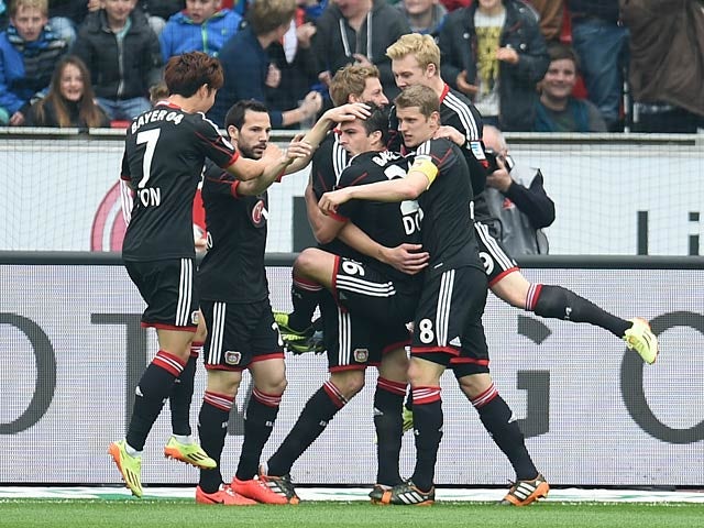 Leverkusen's Stefan Kiessling celebrates with team mates after scoring the opening goal against Hertha Berlin during the Bundesliga match on April 13, 2014